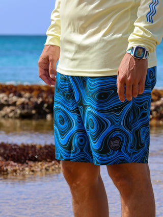 AQWA blue swim shorts with abstract wave pattern, perfect for ocean adventures. Lightweight and stylish for summer days.