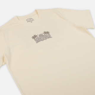 Angled front view of AQWA cream t-shirt showing subtle logo and soft cotton texture – inspired by island surf culture.