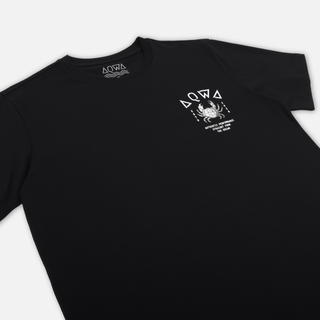 Angled flat lay of AQWA black tee showing chest crab design and aquatic typography – inspired by ocean performance and saltwater lifestyle.