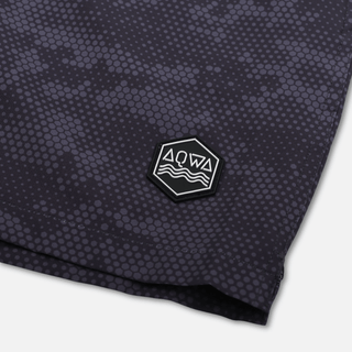 Hexagon AQWA patch on lower left leg – coastal-inspired branding detail on high-performance shorts.