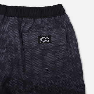 Close-up of AQWA back pocket flap with drainage eyelet and wave logo patch – functional storage for water missions.