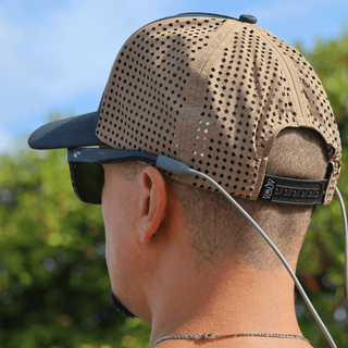 AQWA khaki mesh hat shown from behind, paired with sunglasses and beachwear.