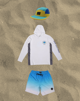 White AQWA hoodie, gradient blue shorts, and multicolor cap, perfect for sunny beach adventures and casual summer looks.