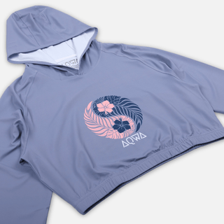 Side angled view of AQWA women’s lavender cropped rash guard featuring floral yin-yang print – beachwear designed for comfort and flow.
